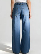 Blue denim wide leg washed jeans with belt and two back pockets showing the back side of leg washed jeans
