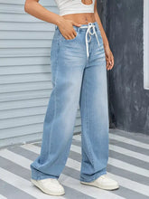 Light-wash denim wide leg washed jeans with white drawstring waistband for comfortable casual wear