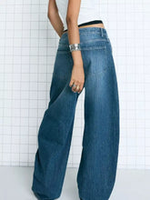 Wide leg washed denim jeans in medium blue with classic stitching and back pockets showing the back side