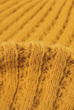 Close-up of mustard yellow wide rib beanie knitted fabric texture