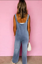 Blue wide strap denim overalls with adjustable straps and pockets