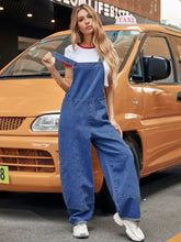 Woman in wide strap wide leg denim overalls and white ringer t-shirt