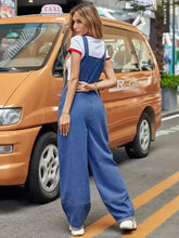 Woman in wide strap wide leg denim overalls and white t-shirt