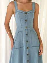 Light blue denim dress with wide strap sweetheart neck, thin straps, and front button closure