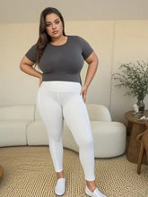 Woman in wide waistband sports leggings and gray top