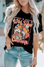 Woman modeling Wild West Cowboys graphic tee with distressed jeans