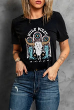 Women’s black short sleeve tee shirt with Wild West graphic and blue jeans