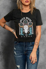 Women’s black short sleeve tee shirt with wild west graphic and distressed blue jeans
