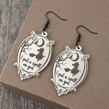 Pair of witch-themed wooden dangle earrings