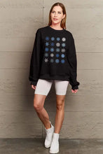 Women’s black round neck sweatshirt with blue and white snowflakes