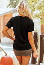 Womens black spooky t shirt with orange text, olive shorts, pumpkin