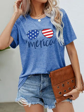 Women’s blue short-sleeve flag glasses graphic tee with America print