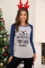 Woman in graphic long sleeve Christmas deer t-shirt with reindeer antlers