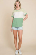 Women’s color block short sleeve t-shirt in mint green and white with denim shorts and sneakers