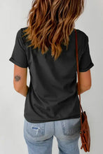 Womens black graphic round neck short sleeve t-shirt with rolled cuffs and distressed light wash jeans