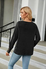 Black long-sleeved V-neck sweater in dark green with regular sleeve length
