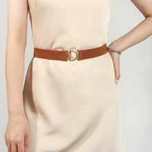 Woman in cream dress with clasp elastic belt and gold buckle