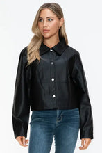 Woman in black cropped womens long sleeve leather jacket and blue jeans
