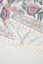 Pink and purple floral lace cotton summer dress with necklace on scalloped tablecloth