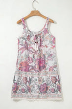 White floral summer dress with pink purple accents and lace hem