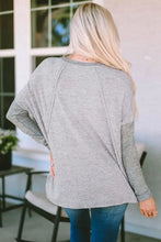 Women’s round neck dropped shoulder light gray long sleeve top with exposed seams