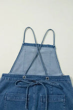 Women’s wide leg denim overalls with adjustable tie straps and cross-back apron pockets