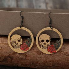Pair of wooden cutout skeleton earrings with skull and rose designs