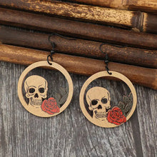 Pair of wooden cutout skeleton earrings with skull and rose dangles