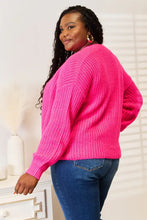 Neon pink drop shoulder cardigan sweater with oversized knit, ribbed details, balloon sleeves, and pockets