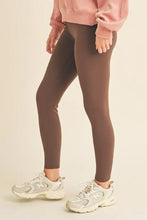 Yelete full size fleece lined high-waisted leggings with dark brown full-length design and light athletic shoes