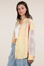 Yellow ribbed knit lace patchwork shacket with orange accents and blue jeans