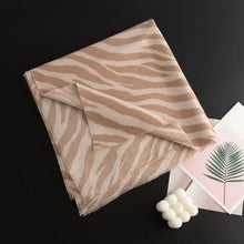 Beige and white animal print polyester scarf with frayed edges