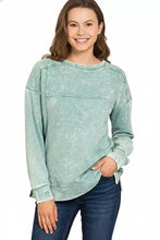 A light teal zenana acid wash french terry pullover with exposed seam and subtle distressing details in relaxed fit