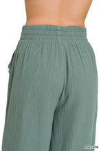A pair of ash jade double gauze lounge pants with wide legs and an elastic waistband made from lightweight fabric