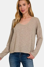 Woman modeling Zenana dropped shoulder long sleeve T-shirt in tan with jeans