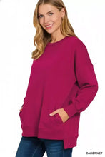 A soft magenta fleece sweatshirt by zenana with a relaxed fit hi-low design and front pockets