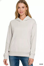 Bone-colored zenana fleece kangaroo pocket hoodie with long sleeves, ribbed cuffs, and slightly stretchy fabric
