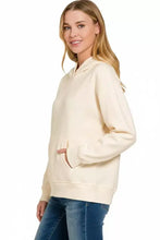 Cream-colored zenana fleece kangaroo pocket hoodie with hood front pockets and ribbed cuffs for casual wear