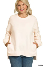 Cream-colored plus size fleece sweatshirt with oversized crewneck, relaxed fit, and front pockets from Zenana