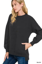 Black oversized fleece boyfriend sweatshirt with side pockets and long sleeves offers best fit and pairing tips for plus size