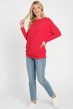A vibrant red zenana hacci dolman sleeve boat neck top with long relaxed sleeves and a comfortable fit