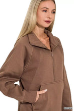 Brown ribbed fleece sweatshirt with half zip and kangaroo pockets providing a perfect fit and cozy comfort