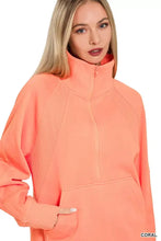 Coral-colored zenana fleece sweatshirt with kangaroo pocket ribbed texture and slightly stretchy fabric on shoulders and sleeves