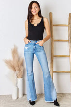 Light-wash denim high-rise flared jeans with frayed hems and distressed patch paired with zenana microfiber notched bodysuit