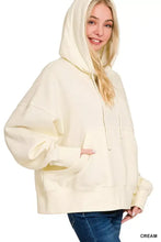 Cream-colored Zenana oversized fleece kangaroo pocket hoodie with relaxed fit and drawstring hood in oversized silhouette