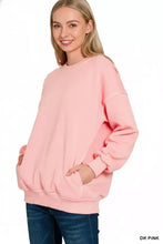 A soft dark pink zenana pigment dye oversized sweatshirt with fleece fabric and ribbed cuffs for relaxed comfort