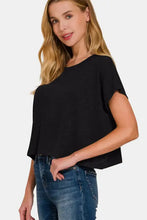 Woman modeling Zenana round neck short sleeve crop t-shirt in black with jeans