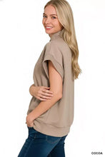 A soft beige zenana scuba high neck half zip top with short loose sleeves and a relaxed fit