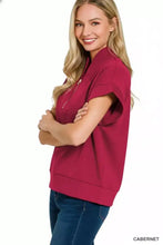 A women’s magenta zenana scuba high neck half zip top with short sleeves and front zipper detail