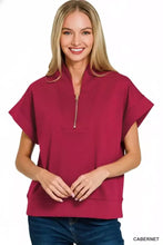 A women’s magenta zenana scuba high neck half zip top with short sleeves and a relaxed fit
